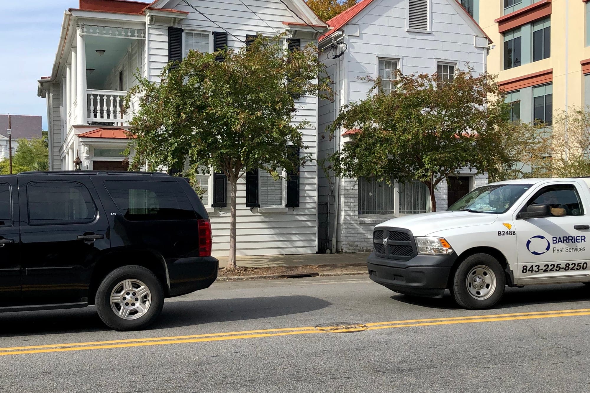Vehicles pass on Calhoun Street in Charleston's Ansonborough neighborhood in October 2019, more than six years before the city installed AI-enabled traffic signals at nine Calhoun Street intersections. No signal is shown.
