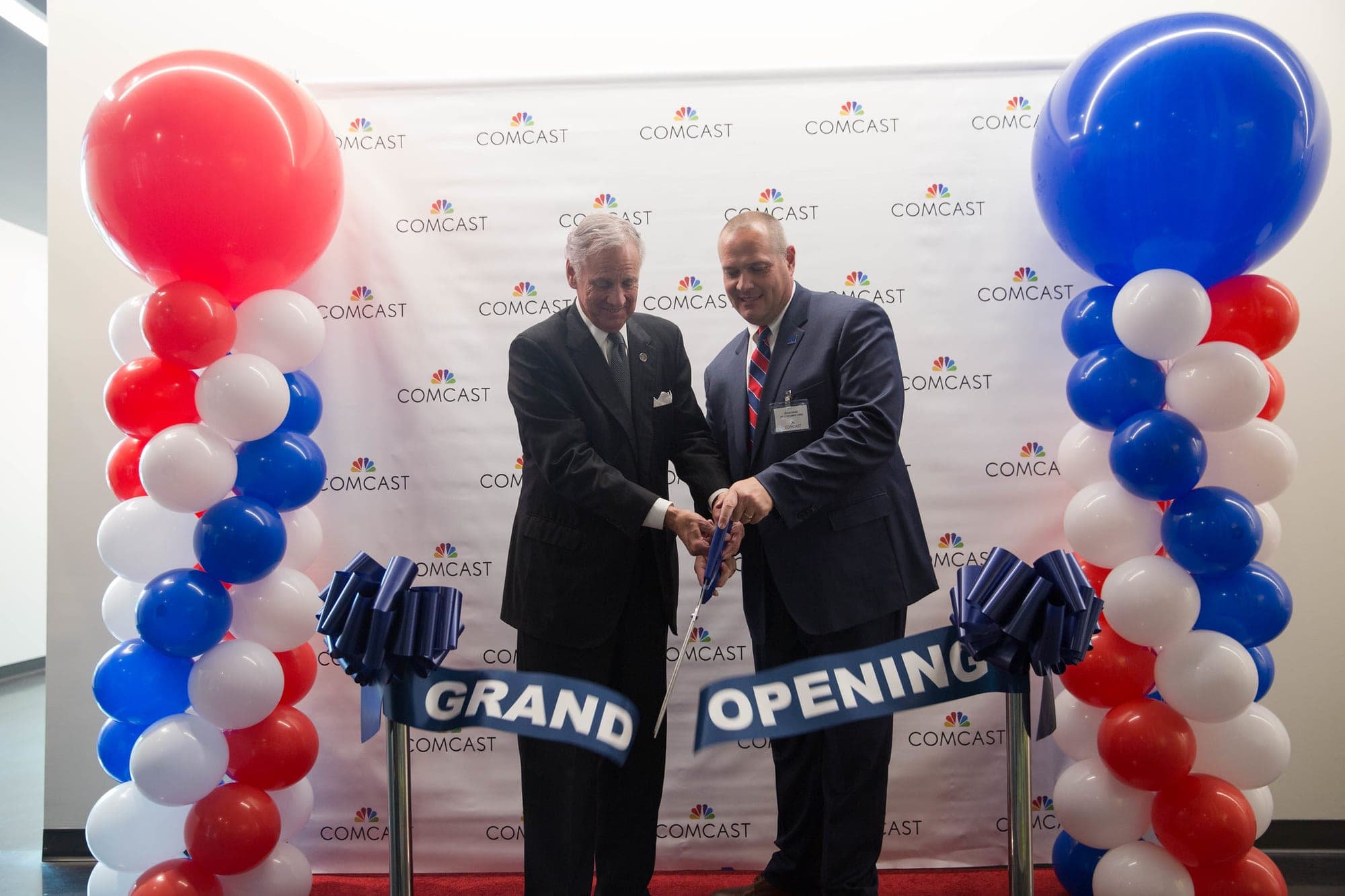 Gov. Henry McMaster, left, cuts a ribbon at Comcast's Charleston Center of Excellence in North Charleston in June 2017. The event was unrelated to Comcast's grant to the AI Academy.