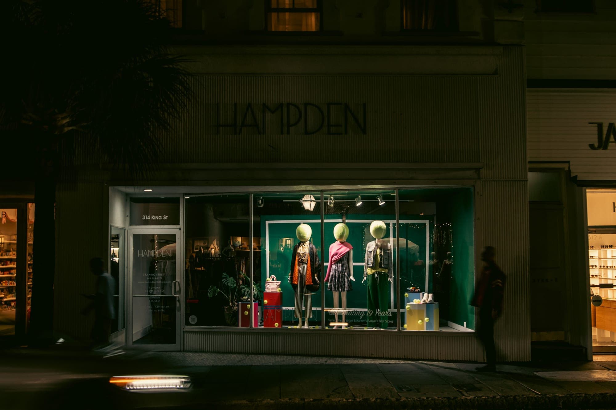 Window displays light Hampden's storefront at 314 King St. in downtown Charleston at night in March 2026.