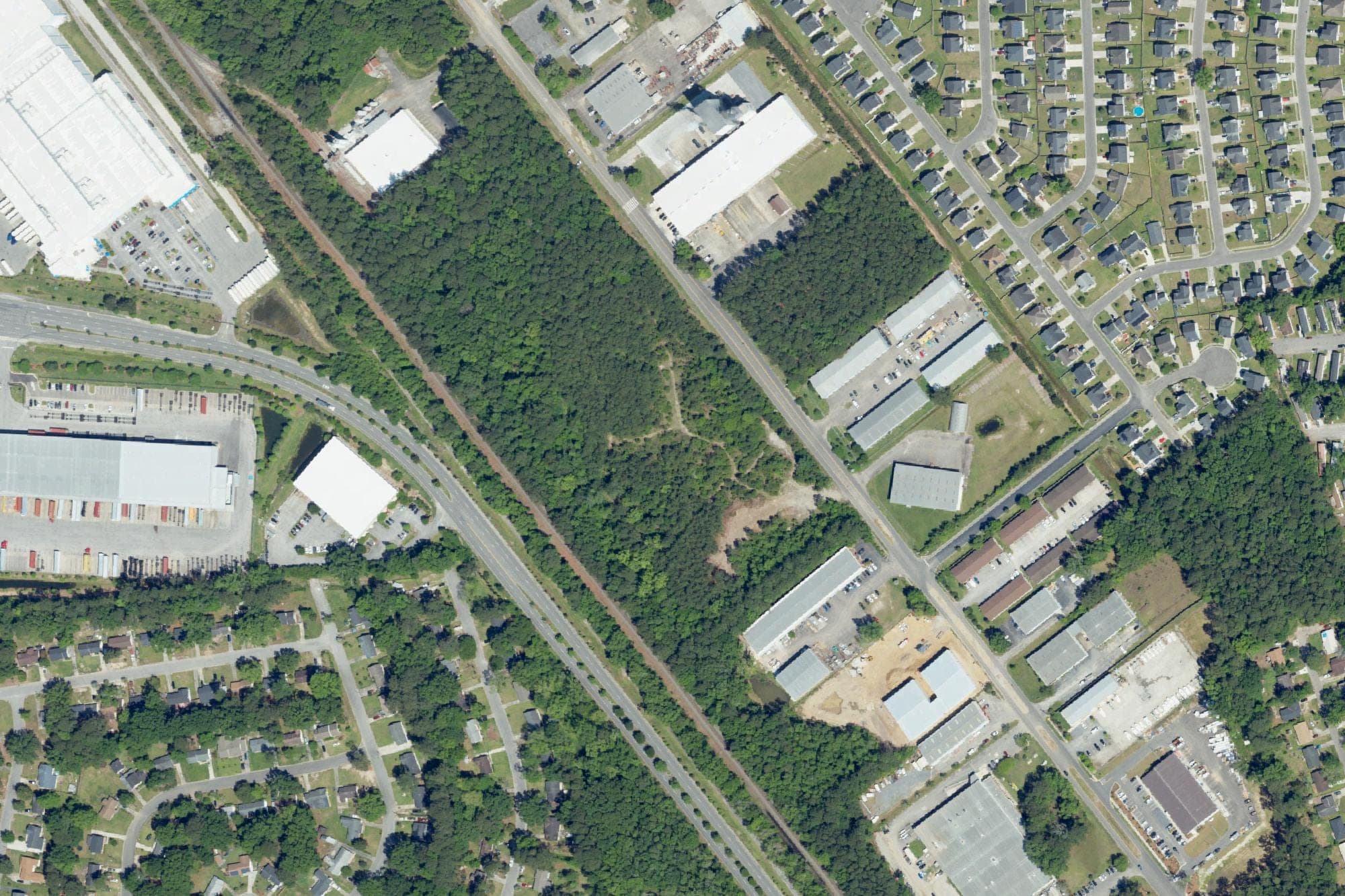 Woods between a rail line and Southrail Road in North Charleston, center, cover the site where Greystar and PGIM have since built Lowcountry Logistics Center Building I, in a U.S. Department of Agriculture aerial image from April 2023, before construction began.