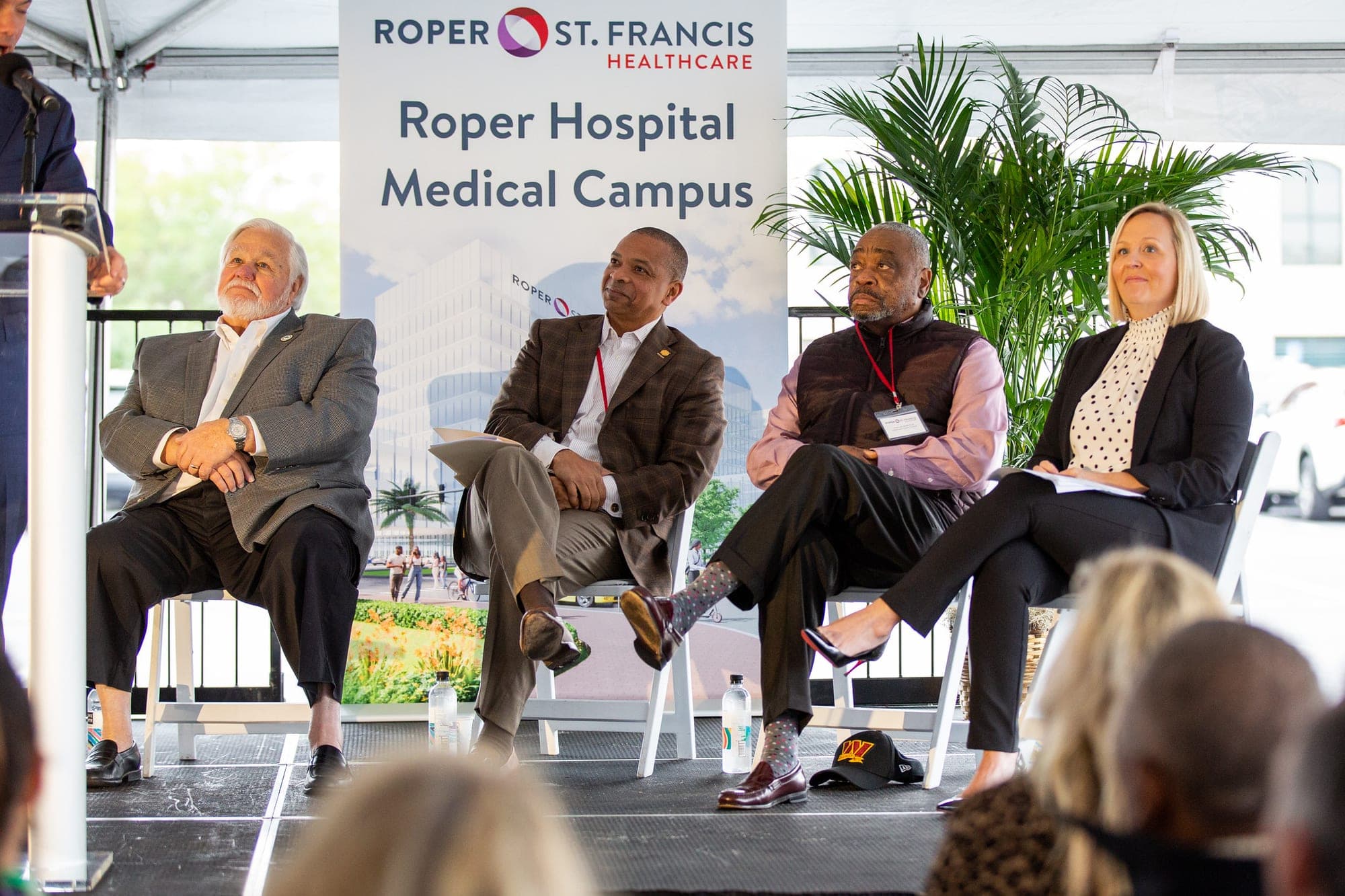 Speakers sit beneath a Roper Hospital Medical Campus banner as Roper St. Francis Healthcare announces its planned North Charleston hospital campus in November 2022.